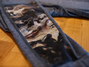 View of the custom watercolor sleeve panel on the Alpine Fit Men's Treeline Long Sleeve base layer.