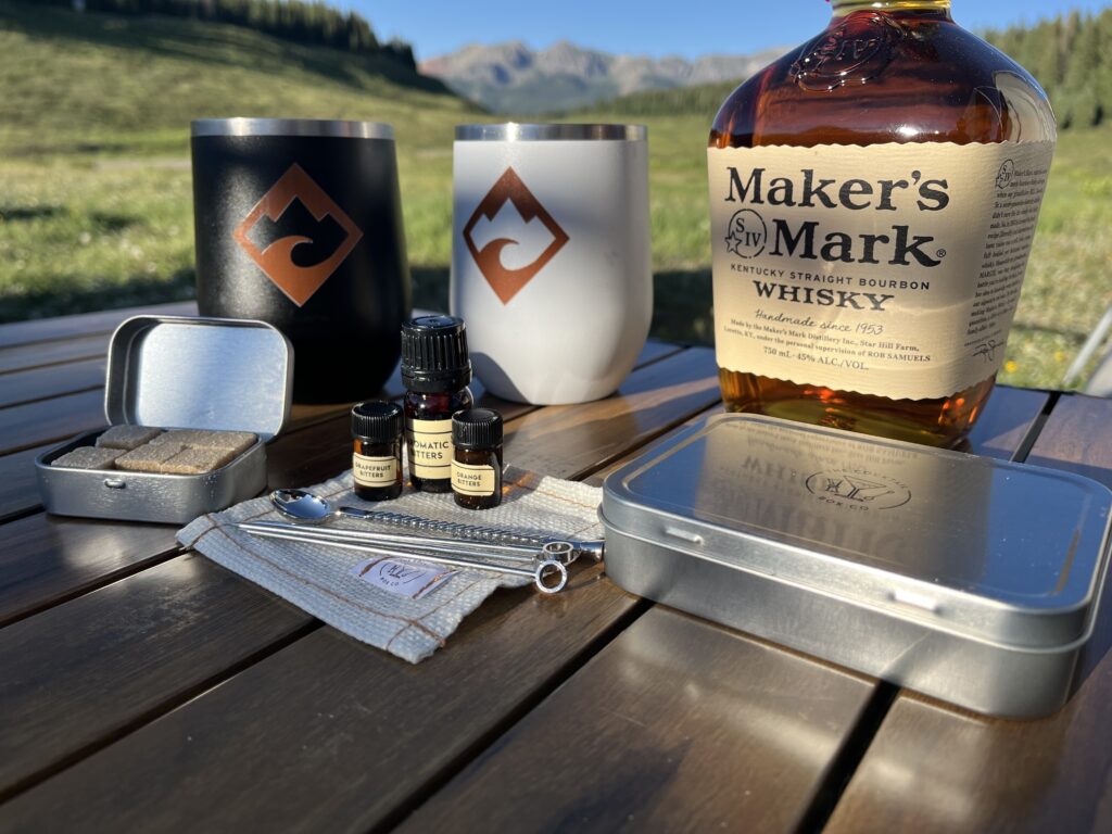 The Cocktail Box Co's Old Fashioned cocktail kit positioned in front of a mountain background.