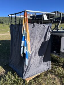 Shower setup of an overland trailer while camping with a Nomadix Towel hanging