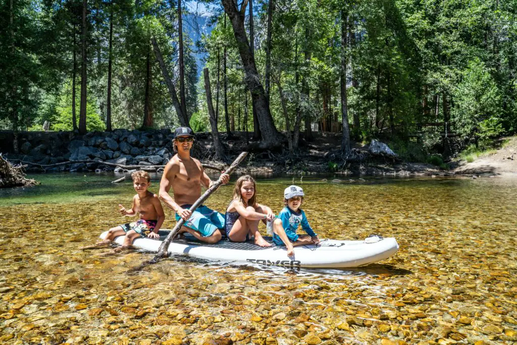 A family of four on a paddleboard together