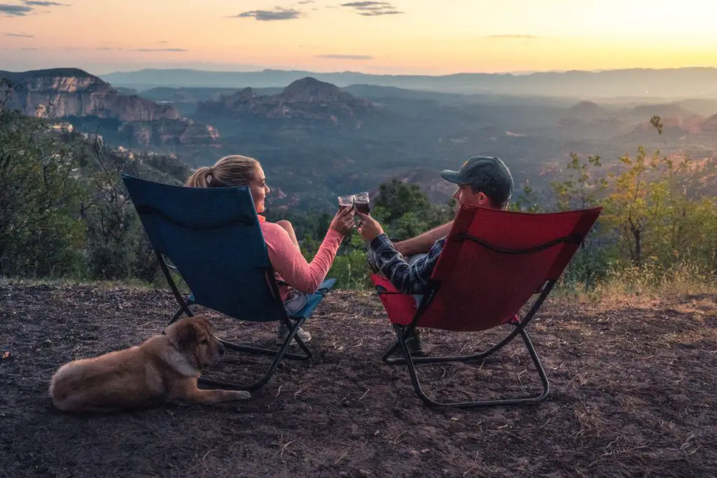 Couple enjoying wine with a view while camping